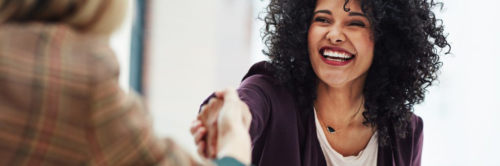 Female applicant shaking hands with Human Resources representative.