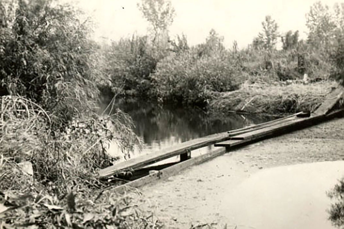 Historic view of a river leading to Madison lakes with wastewater from outhouses and chamber pots as part of the history of the District.