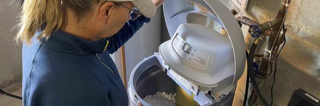 A woman looking into a water softener showing ways service professionals do business with us.