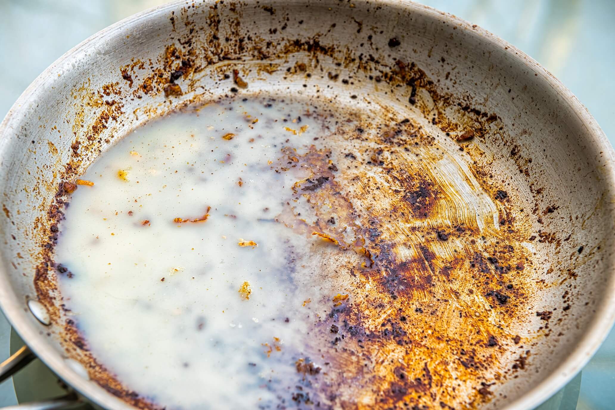 Dirty Oily Pan With Cold Solid Grease Saturated Fat From Bacon After Frying Macro Closeup As Unhealthy Leftover Cleaning Job