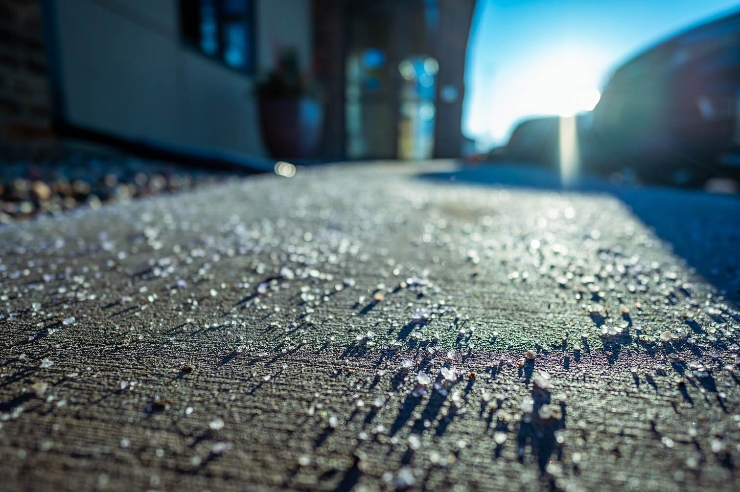 Salt scattered on a sidewalk to demonstrate winter salt reduction strategies.
