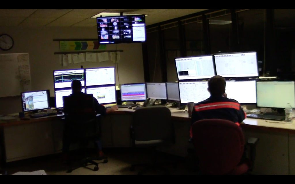 Two night operators monitor multiple computer screens containing SCADA, the District's operations monitoring system.