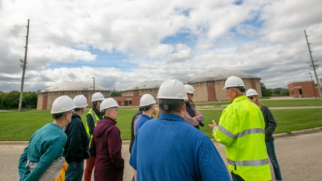 A tour group gathers outside at the plant to learn about operations, safety and maintenance required for wastewater treatment.