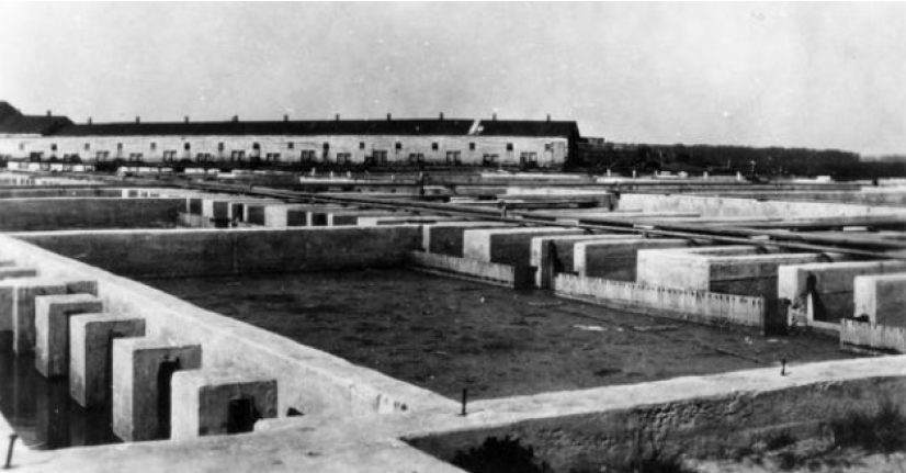 Settling basins and colloidal at the Burke Plant. The main pumping station for sewage collection was located near the Chicago, Milwaukee and St. Paul tracks in Madison, just below the Yahara River. The city garbage was disposed of at Dr. West's piggery, visible in the background.