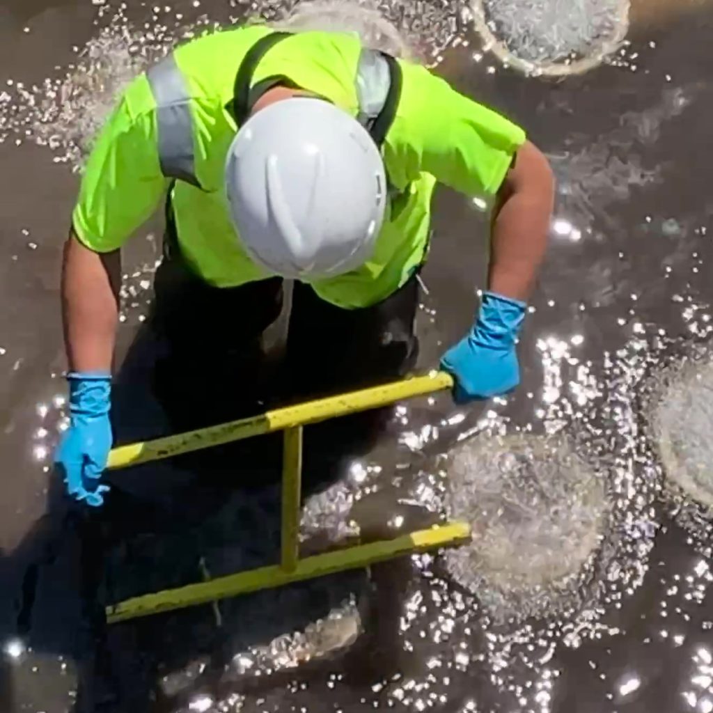 Staff use a special tool to turn diffuser stones to remove and replace faulty O-ring gaskets.