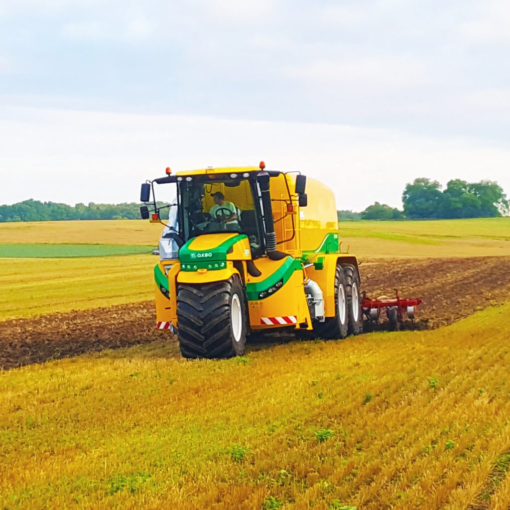 A Metrogro applicator in a farm field. The driver is visible in the cab.