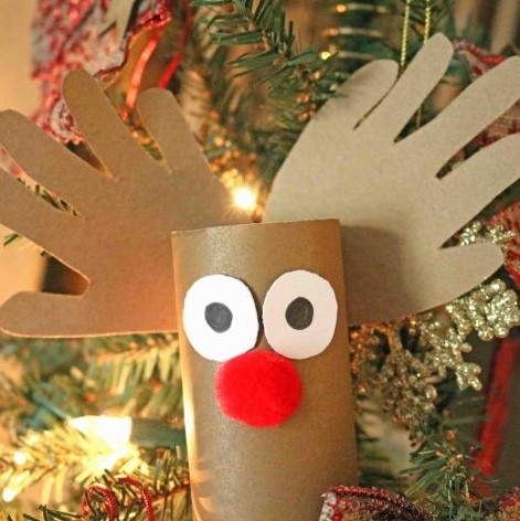 Handmade toilet paper roll Christmas craft reindeer ornament with kids hands.