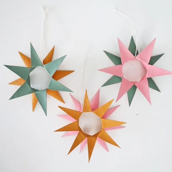 Colored pointed star ornament made from toilet paper (TP) rolls.