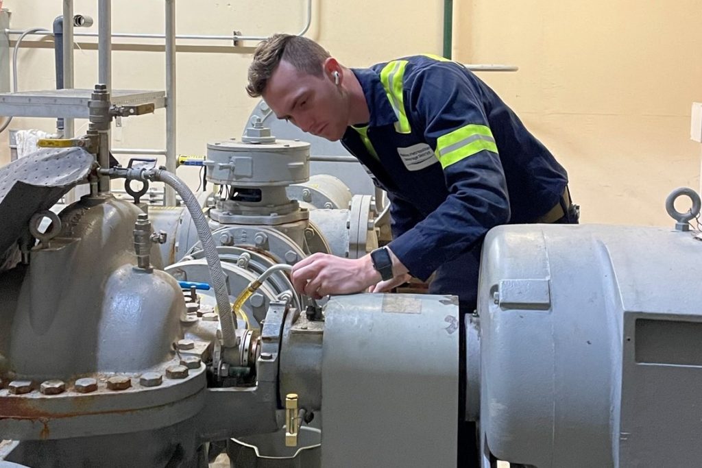 Lubrication technician Matt Rodenkirch changes the oil on a pump in the Effluent Building.