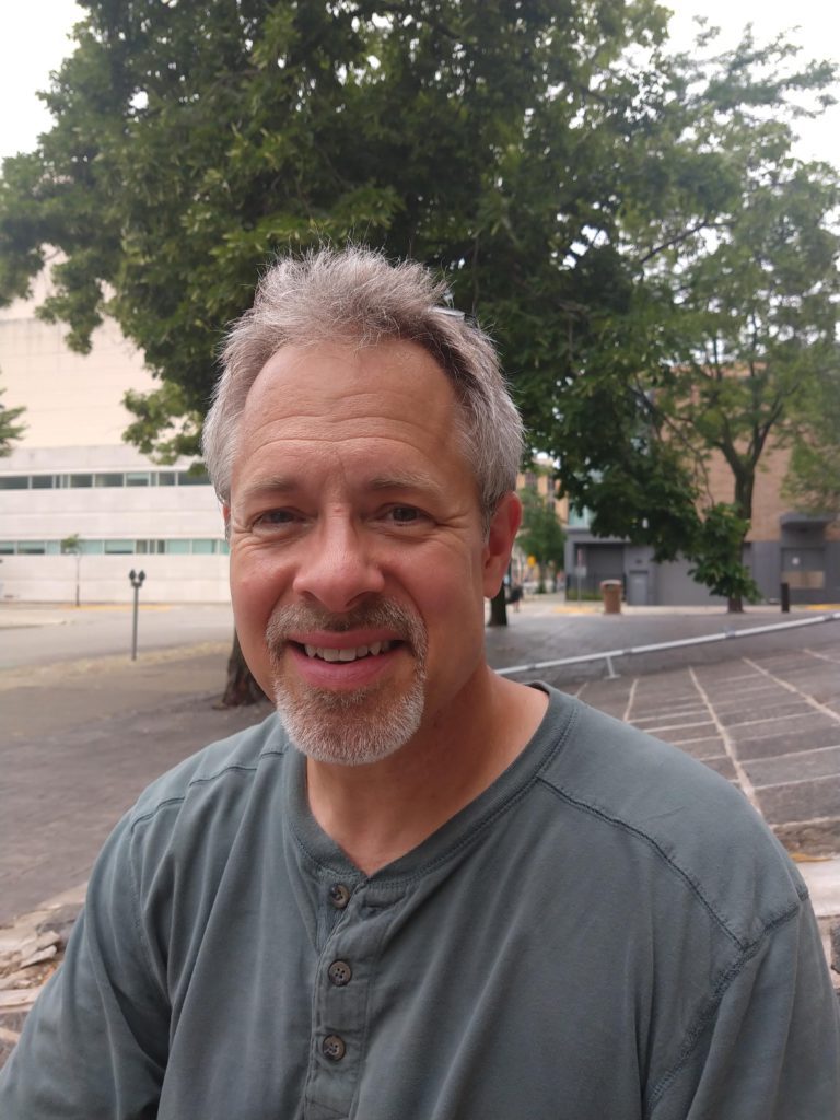 Headshot of Commissioner Greg Fries with a tree in the background.