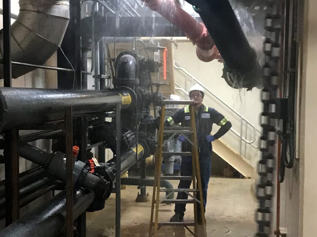 Waiting for the d(rain): Matt Barrett waits for a line to finish draining before starting work on a valve repair.