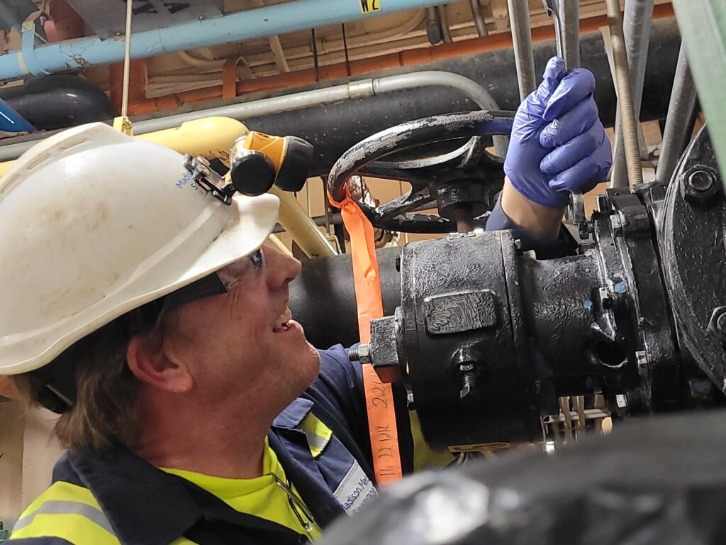 Chip Georgi loosens bolts on a valve bonnet so the plug can be removed and evaluated for repair or replacement.