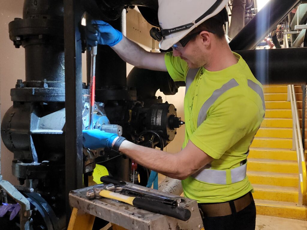 Matt Rodenkirch tightens bolts on completed valve repair using a torque wrench.