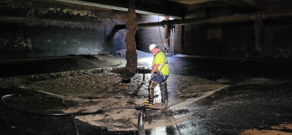 Facilities Maintenance worker Don Martinson works inside WAS blend tank 2.