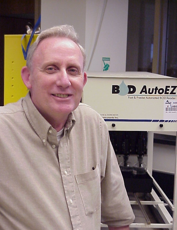 Former lab manager Greg Zelinka and his patented invention, the BOD Auto EZ, an instrument to measure biochemical oxygen demand.