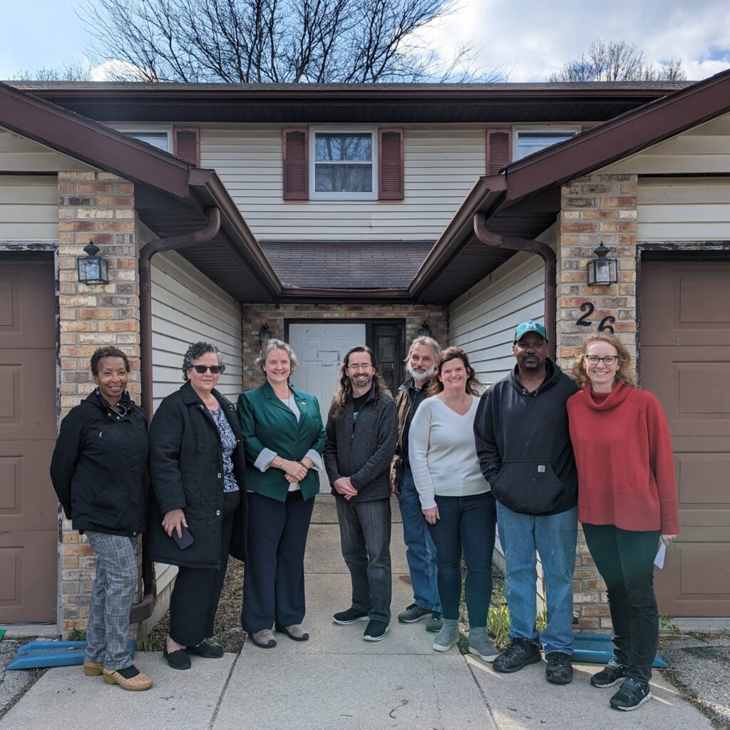 A group of people from the District, Sustain Dane and the City of Madison pose with a property owner that took advantage of water softener optimization through the Efficiency Navigator program.