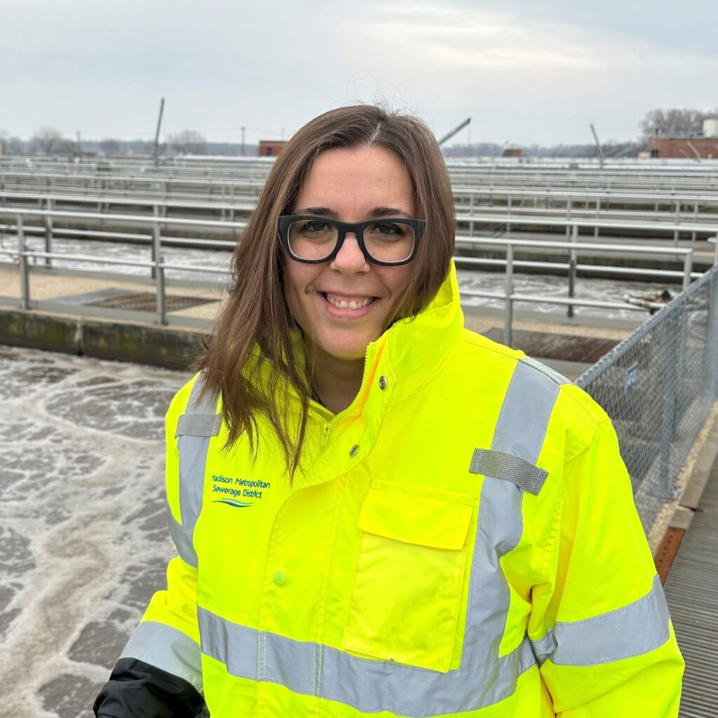 Project engineer Ana Saloni stands in front of aeration tanks at the Nine Springs Wastewater Treatment Plant.