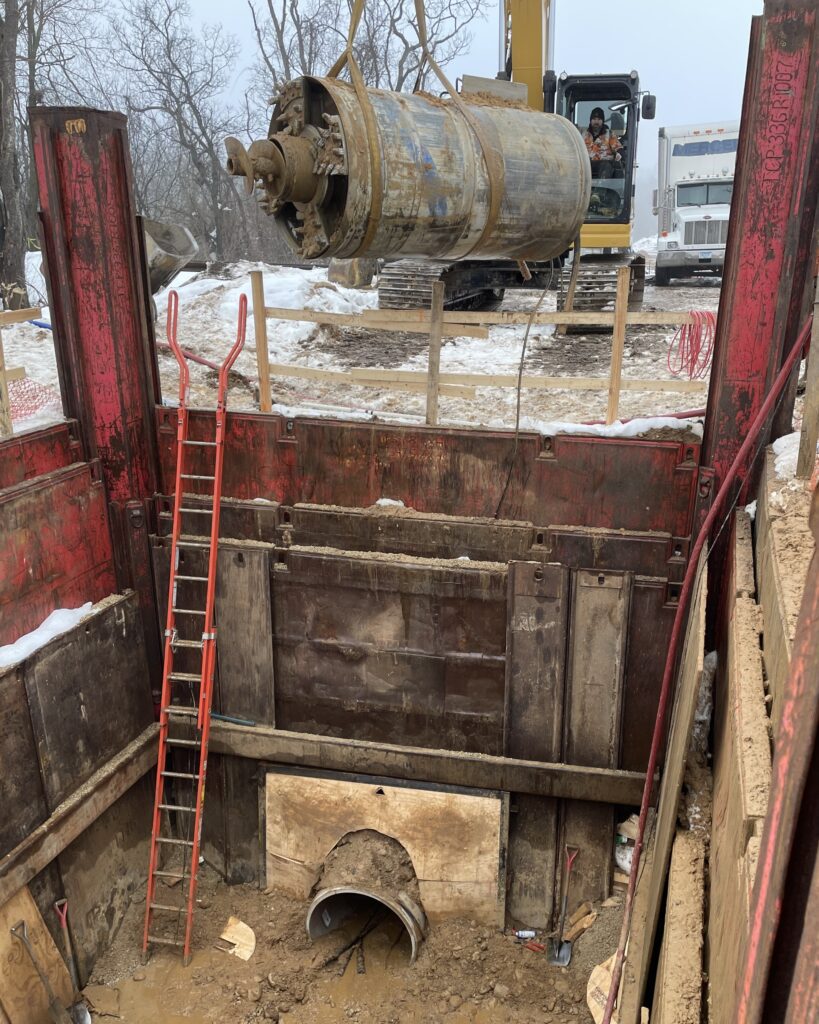 The 16-inch steel auger casing pipes are removed section by section as they are advanced into the receiving pit.