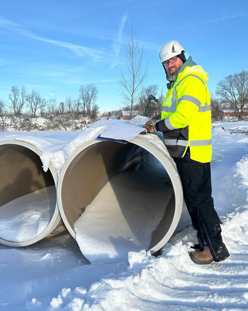 Theran Jacobson, project engineer 2, looks at plans on the Pumping Station 17 Force Main Relief - Phase 2 job site.