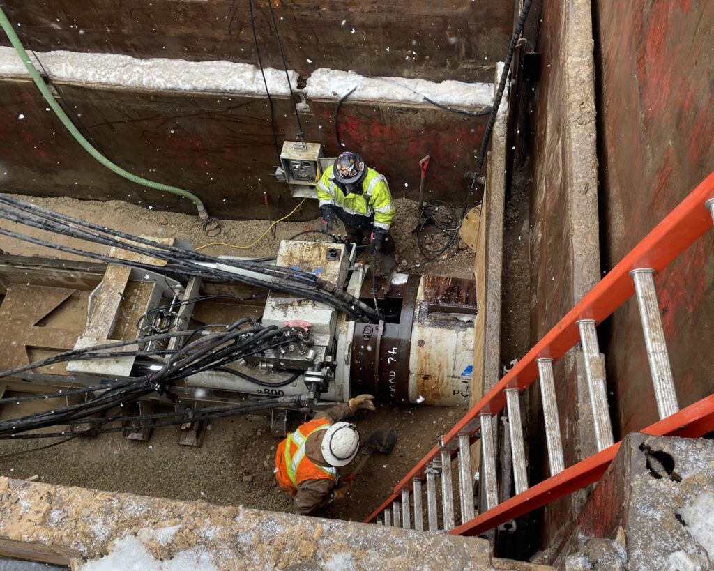 The head is connected to the last 16-inch steel auger casing pipe and partially advanced into the tunnel.