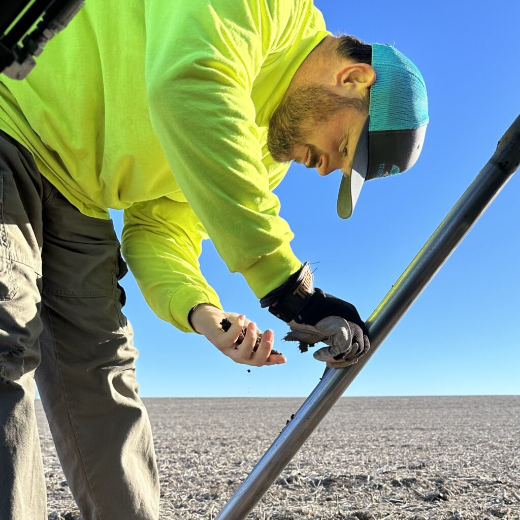 A biosolids specialist analyzes the soil before Metrogro is applied to fields.