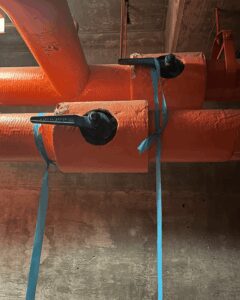 A blue ribbon on a valve communicates that it is involved in scheduled work.
