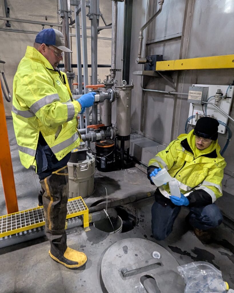 Mike Kressin and Griffin Bohm on the CSS crew collect wastewater samples near one of the metal finishing areas at Graber.