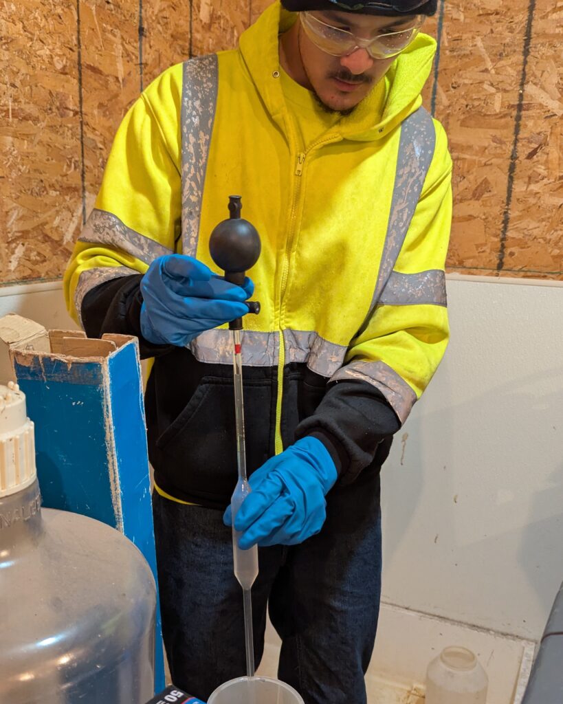 CSS crew member Griffin Bohm uses a pipette to extract small amounts of wastewater to fill tiny sample bottles. “I love it,” says Griffin of IP sampling, “I get to feel like a chemist for a bit.”