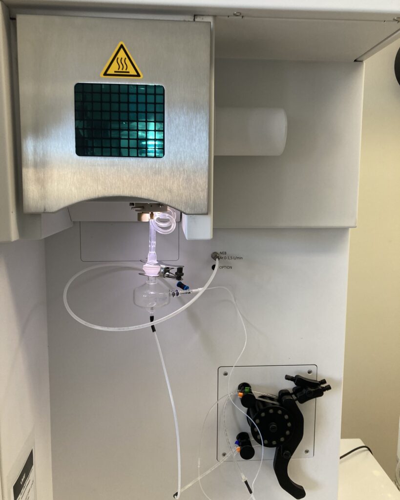 The Spectrogreen ICP instrument is how we analyze metals in IP samples – a sample is introduced into the instrument, aspirated into an aerosol (white glow) and then injected into the plasma (green glow). The plasma excites the atoms, which release energy in the form of light, resulting in spectra specific to individual elements.