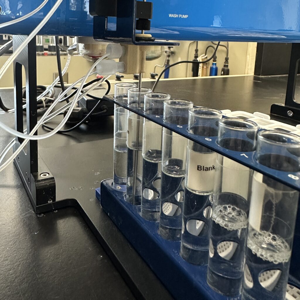An automated machine measures ammonia in a row of test tubes.