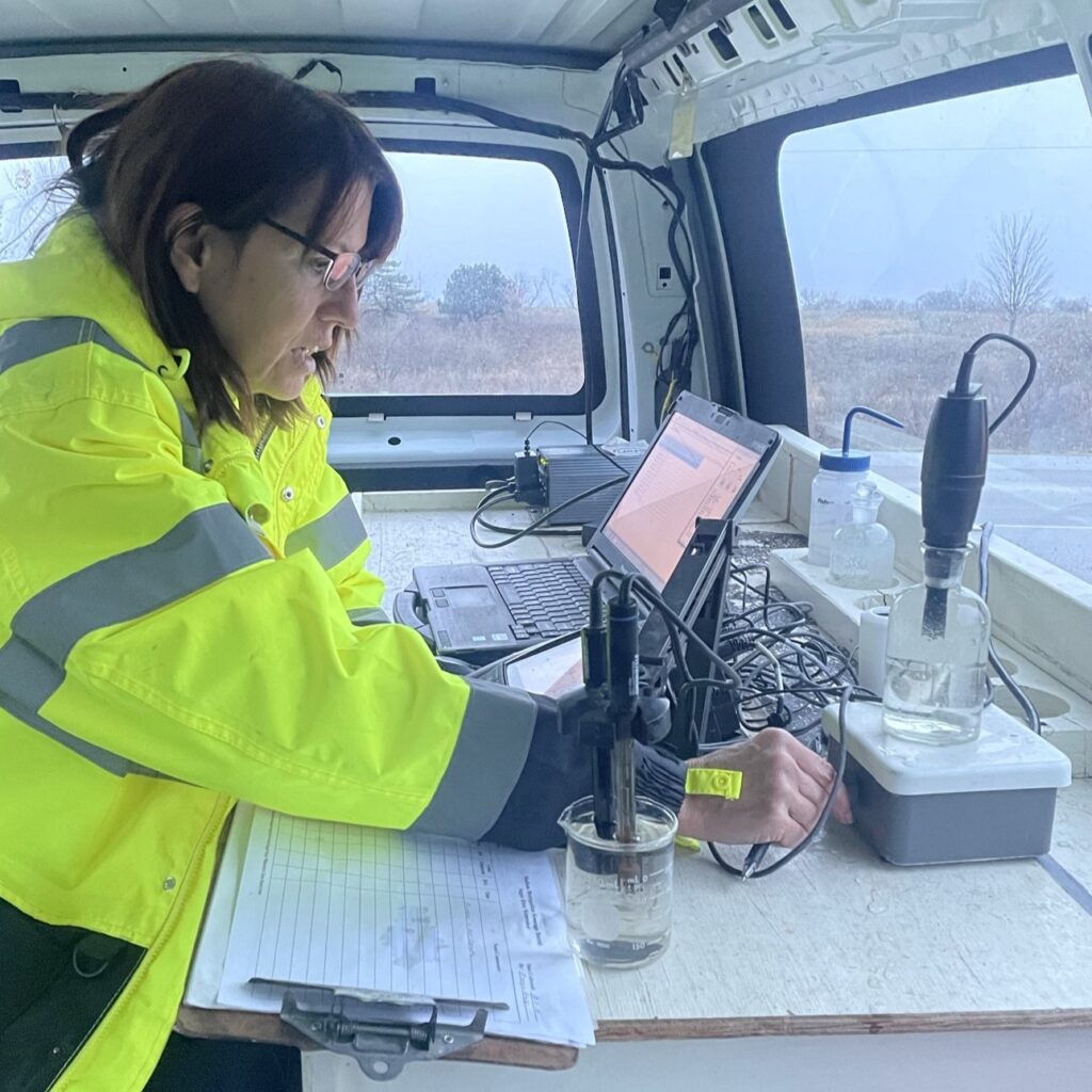 A chemist measures conductivity in the mobile lab van.