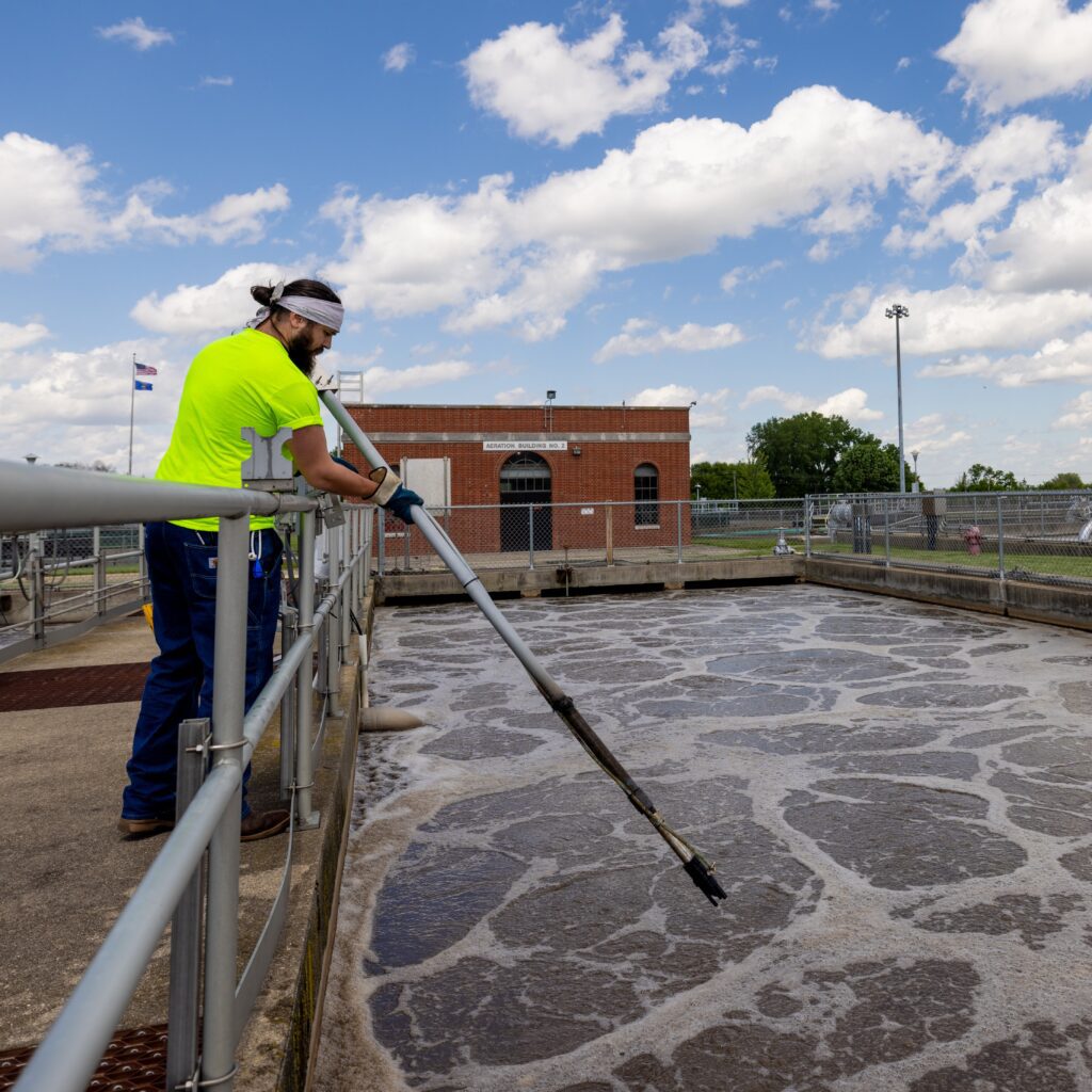 An operator looks at DO levels in the aeration tanks.