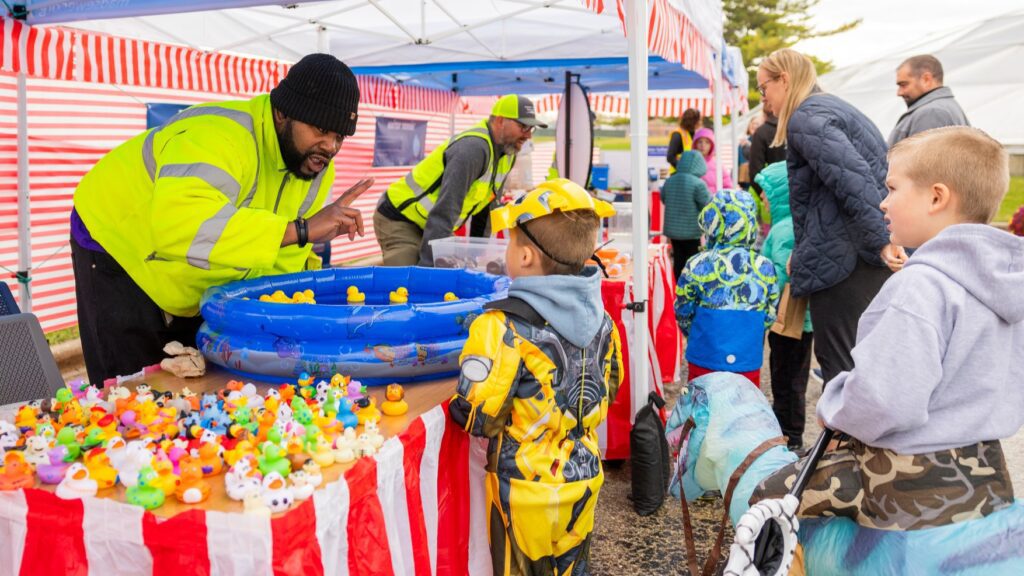 Families having fun playing mini carnival games as part of the Clean Water Showcase event.