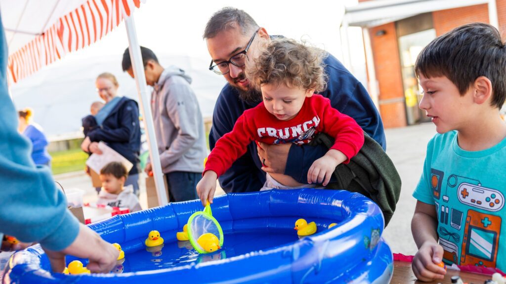 Families having fun playing mini carnival games as part of the Clean Water Showcase event.