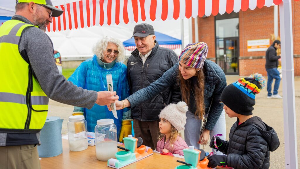 Families having fun playing mini carnival games as part of the Clean Water Showcase event.