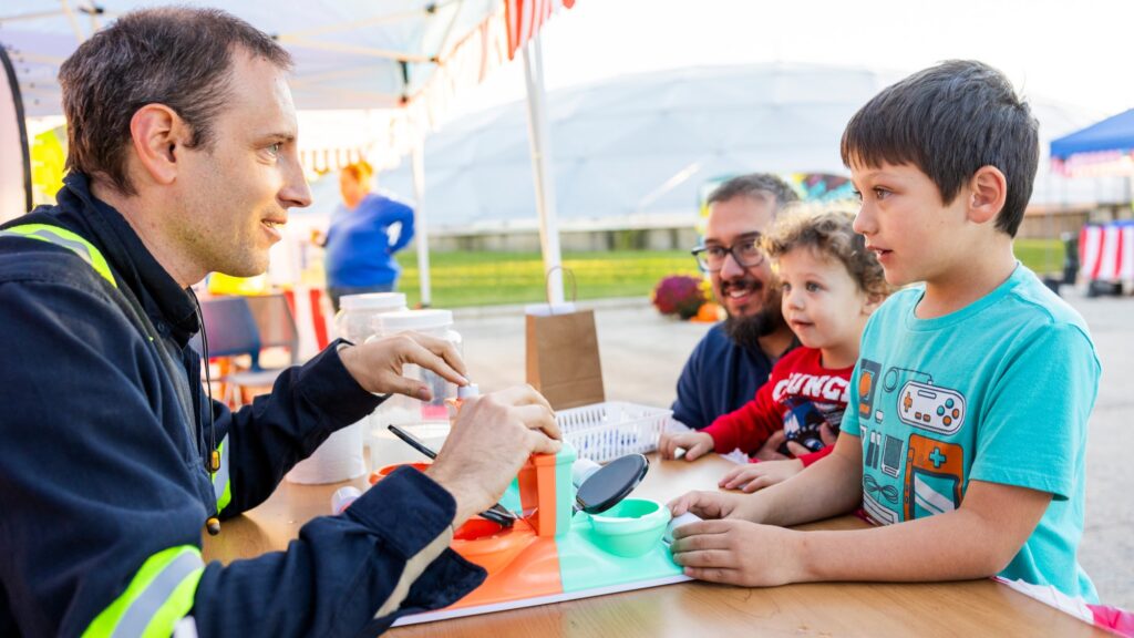 Families having fun playing mini carnival games as part of the Clean Water Showcase event.