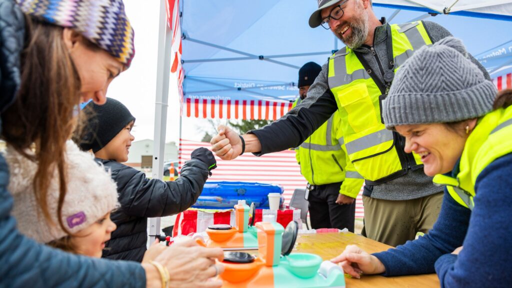 Families having fun playing mini carnival games as part of the Clean Water Showcase event.
