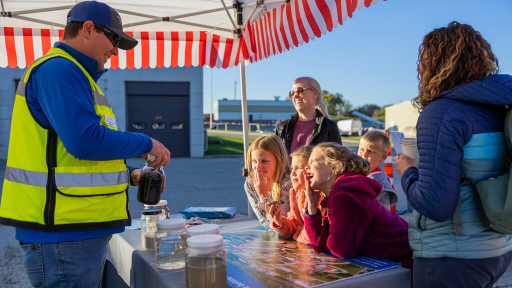 Families having fun learning about wastewater treatment as part of the Clean Water Showcase event.