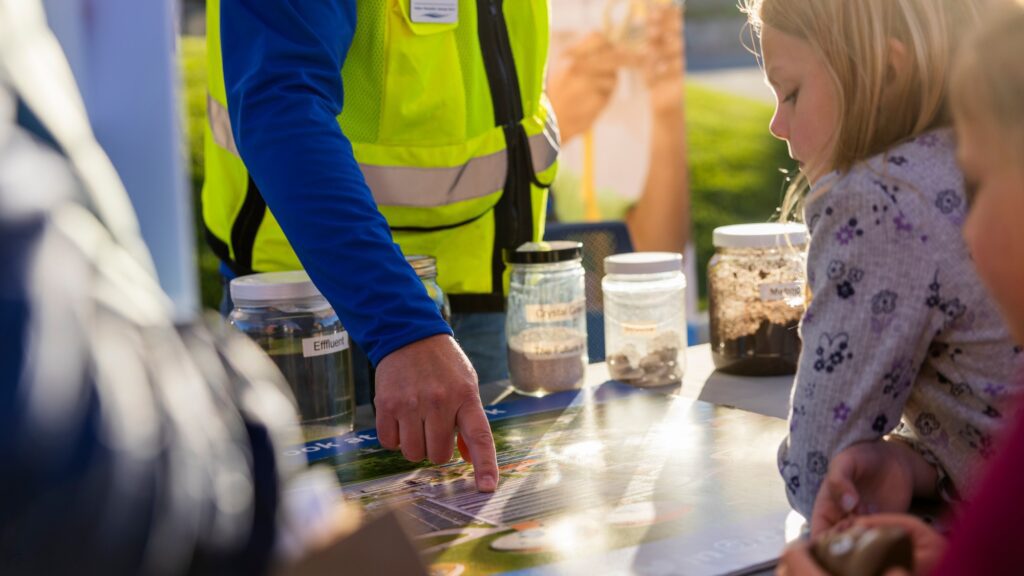 Families having fun learning about wastewater treatment as part of the Clean Water Showcase event.