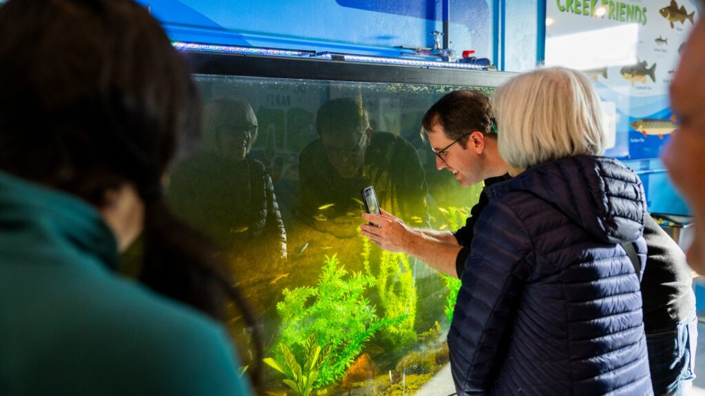 Families having fun learning about effluent in the Fish Room as part of the Clean Water Showcase event.