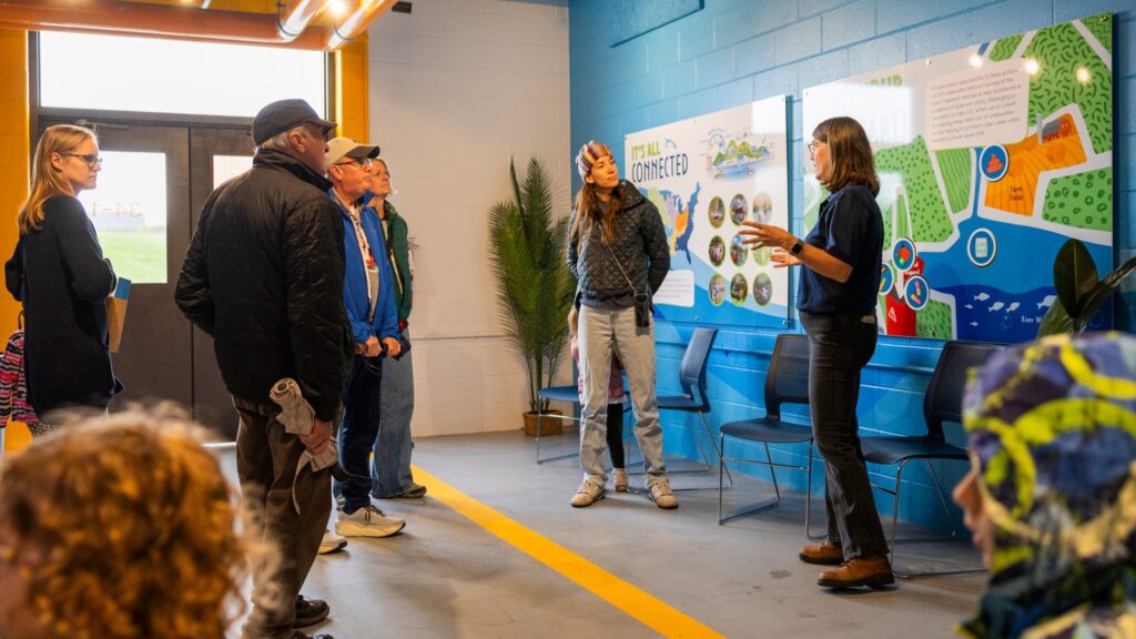 Families having fun learning about effluent in the Fish Room as part of the Clean Water Showcase event.