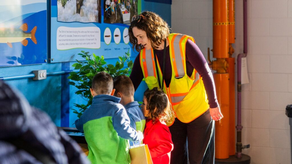 Families having fun learning about effluent in the Fish Room as part of the Clean Water Showcase event.