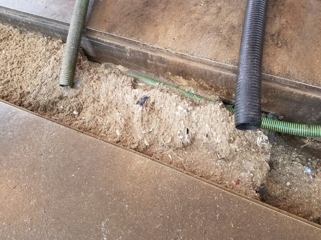 Hauled grease trap waste filling the septage receiving trough.