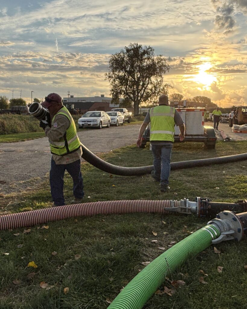 Roy Wells, Brady Lessner and Don Martinson (not pictured) set up the PS 3 bypass pumping system on the first day of the PS 2 force main repair.