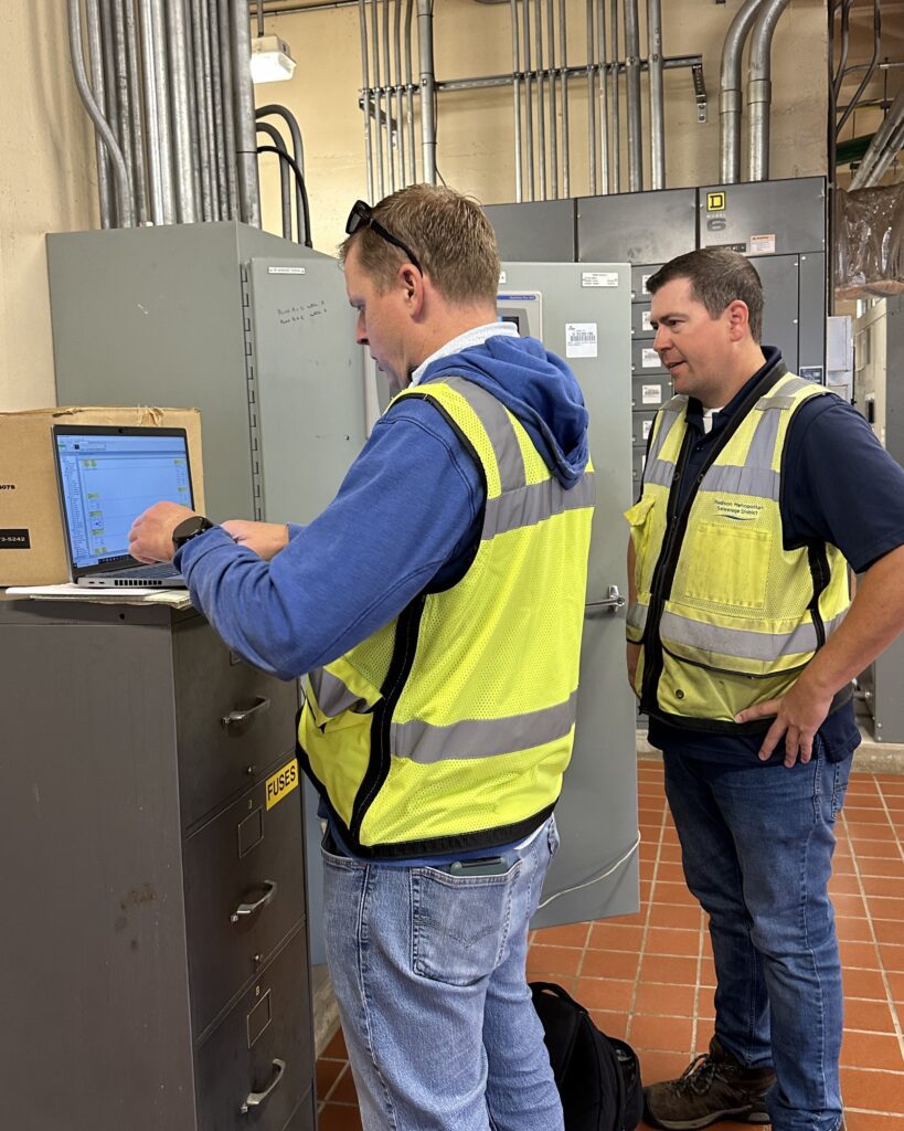 Craig Palzkill and Erik Rehr adjust pump speeds at PS 1 to initiate the flow reroute and allow the PS 2 force main repair to begin.
