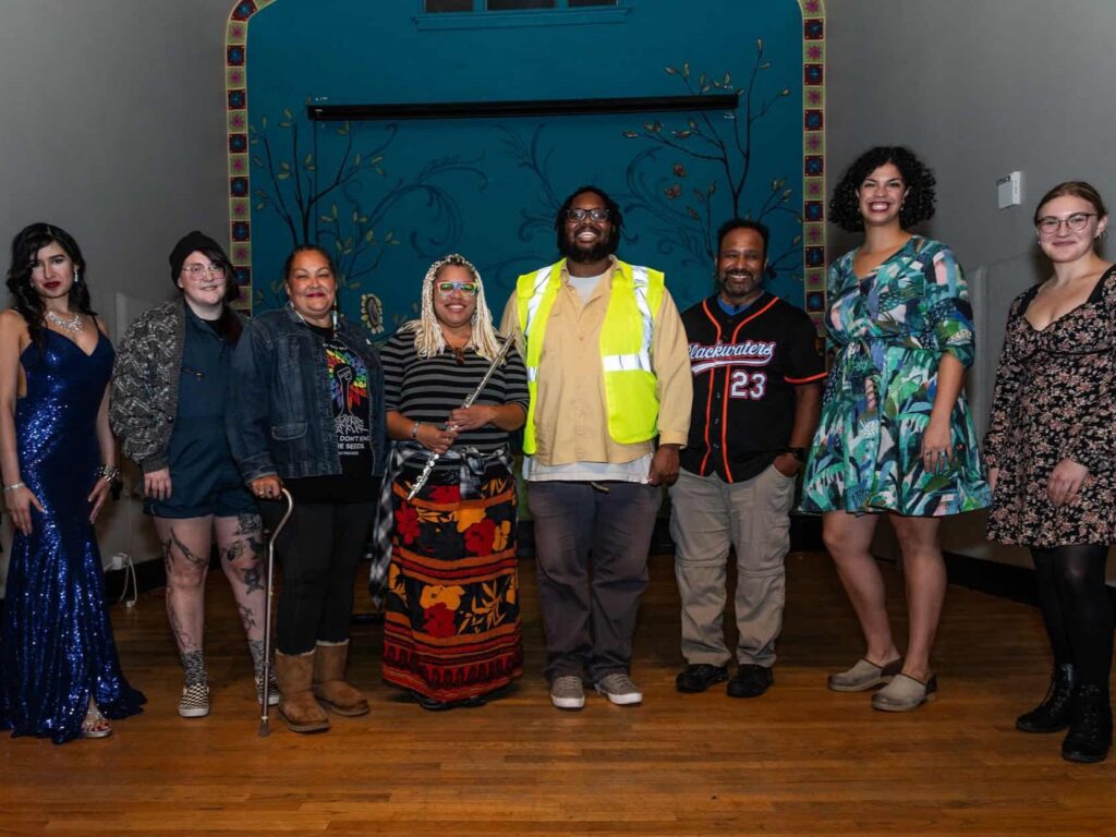 The group of speakers and participants for the "By the Water" Story Slam event.