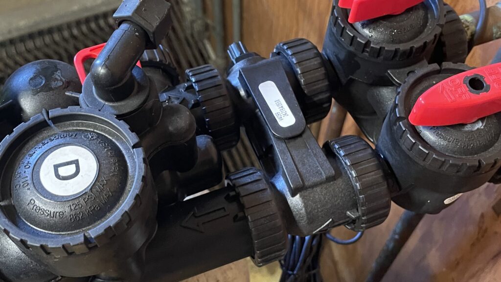 A softener professional shows the position of an installed blending valve on a water softener.