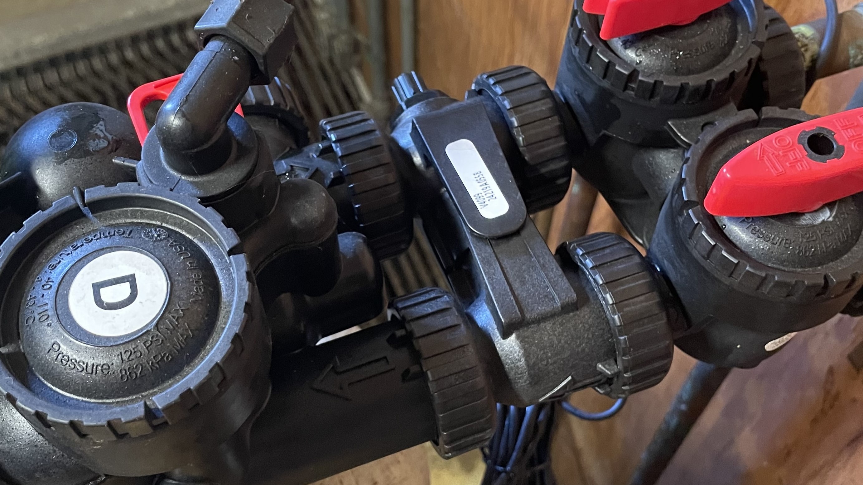 A softener professional shows the position of an installed blending valve on a water softener.