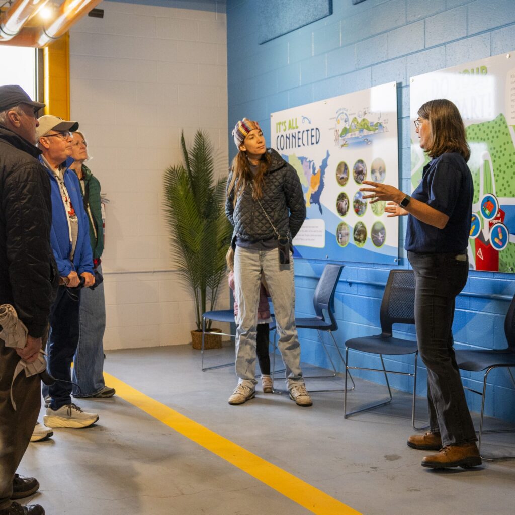 A pollution prevention team member educates the public on the water cycle in the Effluent Building.