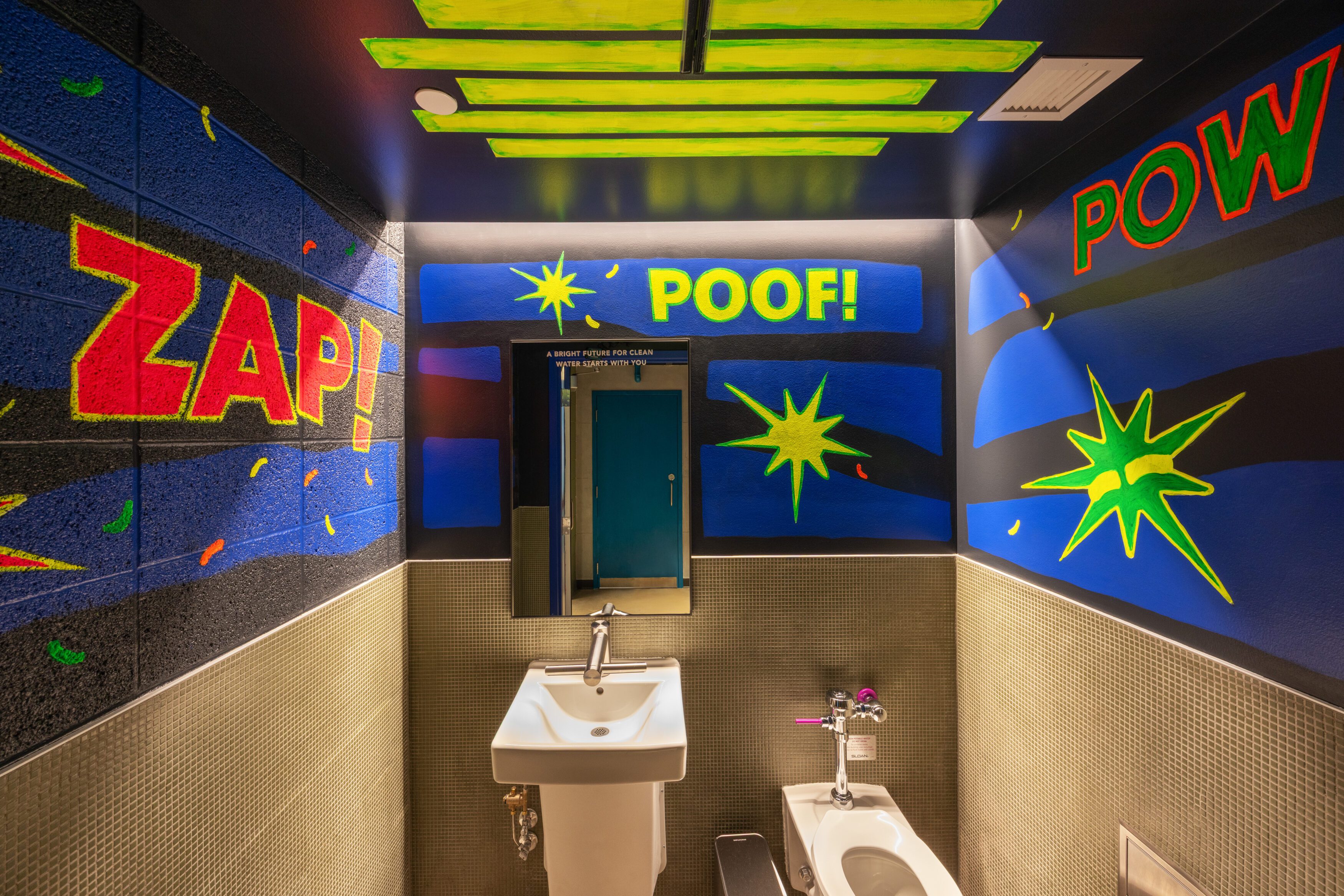 The UV-themed bathroom at the Madison Public Market relies on bright visuals to educate on UV light as a final step of wastewater treatment. The UV-themed bathroom at the Madison Public Market relies on bright visuals to educate on UV light as a final step of wastewater treatment.